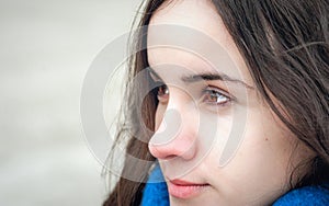 Abstract portrait of young beautiful girl with sad and adorable eyes with sensitive look in the cold day extremely close up