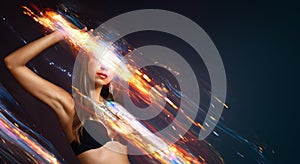 Abstract portrait of young woman performing fire show