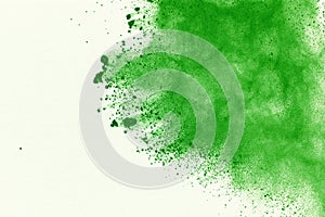 Abstract powder splatted background,Freeze motion of green powder exploding/throwing green dust.