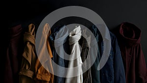 Abstract presentation of different types of clothes on dark background