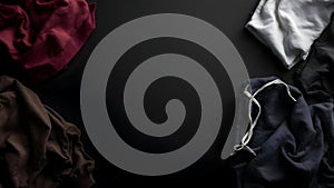 Abstract presentation of different types of clothes on dark background
