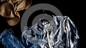 Abstract presentation of different types of clothes on dark background
