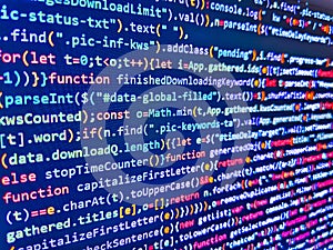 Abstract program code on computer screen. Developing programming binary code. In. Programmer working in a software develop company