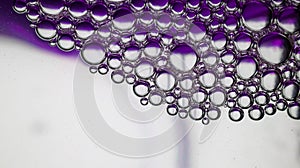 Abstract purple-graded water background and transparent soap bubble pattern