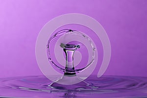 Abstract purple water drop collision