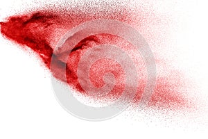 Abstract red dust splattered on white background. Red powder explosion.Freeze motion of red particles splashing