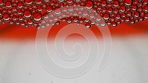 Abstract red-graded water background and transparent soap bubble pattern