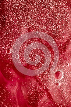 Abstract red liquid background, paint splash, swirl pattern and water drops, beauty gel and cosmetic texture