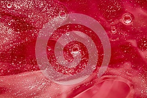 Abstract red liquid background, paint splash, swirl pattern and water drops, beauty gel and cosmetic texture