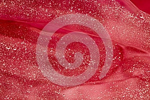 Abstract red liquid background, paint splash, swirl pattern and water drops, beauty gel and cosmetic texture