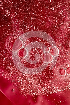 Abstract red liquid background, paint splash, swirl pattern and water drops, beauty gel and cosmetic texture