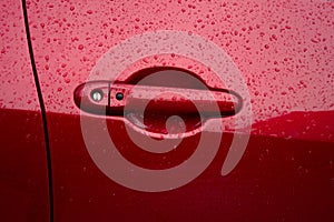 Abstract red metal background. Wet rain drops on the metal red car after rain.