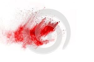 Abstract red powder splatted on white background.