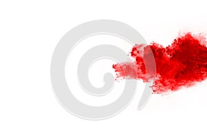 Abstract red powder splatted on white background.