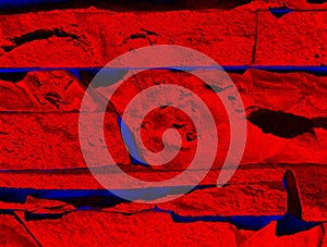 Abstract, red, volumetric background, with blue longitudinal stripes, from photo products of stone tiles for facing.