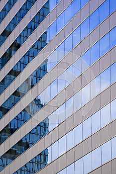 Abstract reflection pattern of high office building on blue glass wall surface of skyscraper