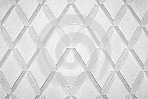 Abstract rhombus shape white and black color background close up, gray concrete wall with diamond texture pattern, rhomb ornament