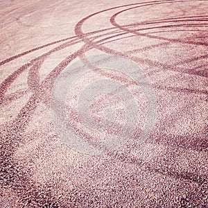 Abstract road background with tire tracks on the asphalt - vintage effect.