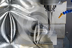 The abstract scene of CNC milling machine rough cutting the injection mold parts by solid endmill tools. photo