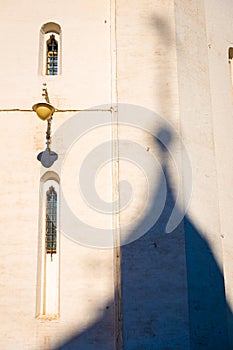 Abstract scene of dome shadow touching on old church building wall in Russia