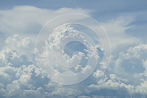 Abstract scene of powerful free form white cloud with shades of blue sky background