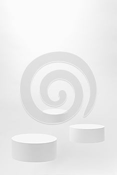 Abstract scene - three round white tilt podiums for cosmetic products mockup, fly on white background