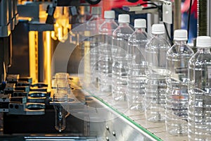 The abstract scene of tube preform shape of bottles preheat process and the plastic bottle in the conveyor belt.