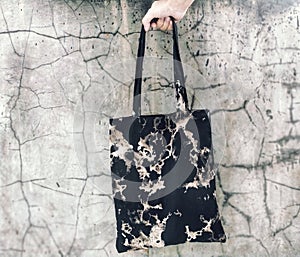 an abstract scrumble black tie dye totebag