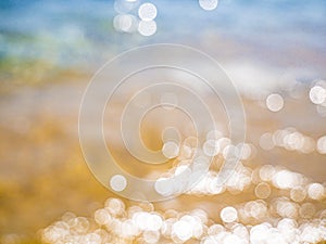 Abstract sea background. Abstract sandy summer beach background with bokeh lights on light blue sky. Beautiful texture. Space