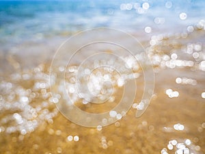 Abstract sea background. Abstract sandy summer beach background with bokeh lights on light blue sky. Beautiful texture. Space