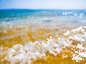 Abstract sea background. Abstract sandy summer beach background with bokeh lights on light blue sky. Beautiful texture. Space