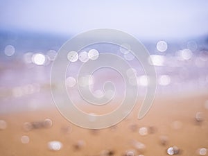 Abstract sea background. Abstract sandy summer beach background with bokeh lights on light blue sky. Beautiful texture. Space