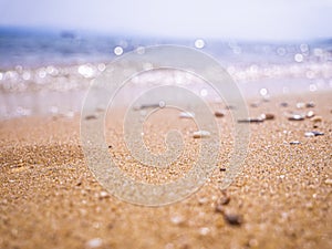 Abstract sea background. Abstract sandy summer beach background with bokeh lights on light blue sky. Beautiful texture. Space