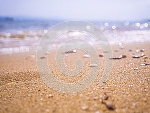 Abstract sea background. Abstract sandy summer beach background with bokeh lights on light blue sky. Beautiful texture. Space