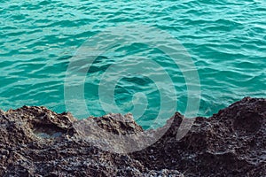 Abstract sea background volcanic stones front