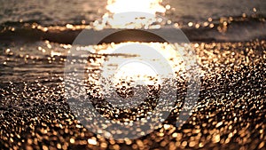 Abstract sea beach summer ocean sunset nature background. Sound of small waves on golden water surface in motion blur