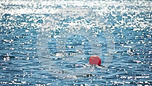 Abstract sea summer ocean sunset nature background. Small waves on azure water surface in motion blur with golden bokeh