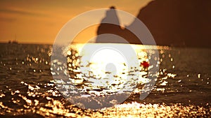 Abstract sea summer ocean sunset nature background. Small waves on golden water surface in motion blur with golden bokeh