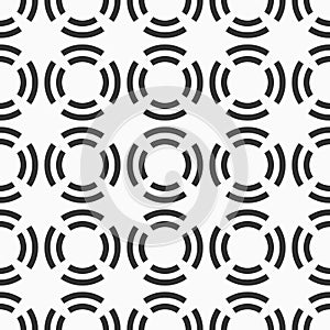 Abstract seamless pattern of circles divided into four parts.