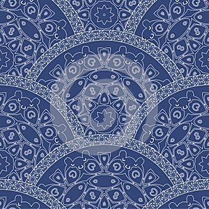 Abstract seamless wavy pattern from decorative ethnic ornaments with dark blue paint texture. Regular fan or peacock tail shaped