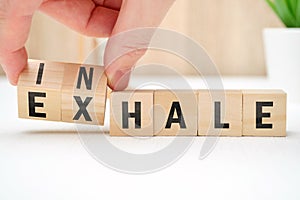 Abstract selection of inhale exhale phrases on wooden blocks