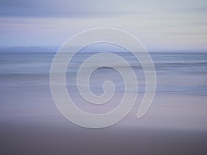 Abstract shades of blue and violet beach over the ocean. Deliberate in camera movement