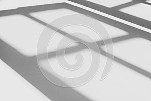 Abstract shadow of the window in morning light on white wall