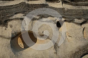 Abstract shapes, patterns and textures of limestone surface with holes