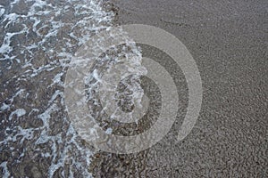 Abstract shapes, patterns and textures of waves on beach sand