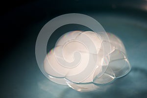 Abstract shot with big soap bubbles on a water surface with smoke