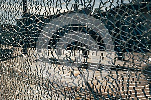 Abstract shot blurred summery city square through cracked broken glass. Conceptual avant-garde background for a website