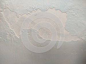 abstract shot of a wall or surface showing signs of paint damage.