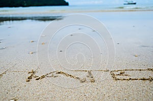 Abstract sign of word hate written on a sand beach background