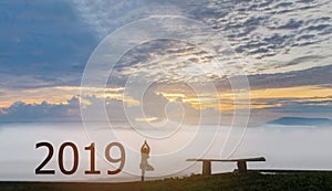 abstract silhouette the 2019 with woman stand exercise yoga,the beautiful sky mountain view by beam light and lens flare